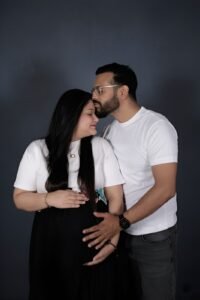 Couple maternity studio photoshoot in Faridabad – Alok Color Lab professional pregnancy photography with elegant indoor themes and lighting.