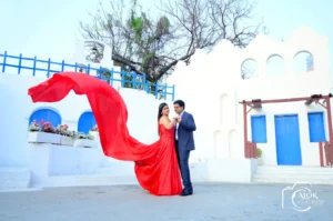 Couple sharing a romantic moment during a pre-wedding photoshoot with scenic background.